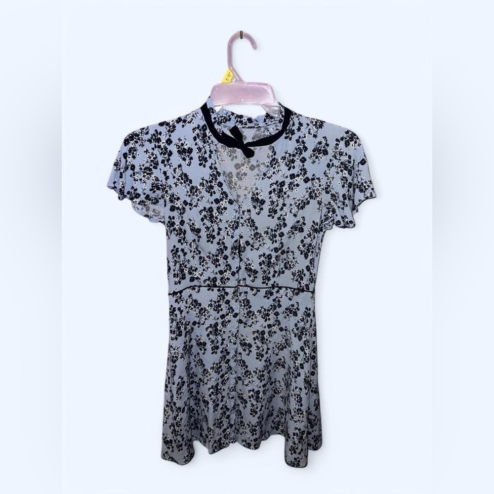 Blue floral coquette dress with black trim, short sleeves, and bow tie